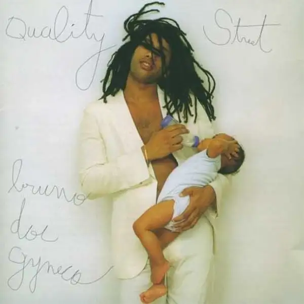 Doc Gyneco holding a baby in his arms.